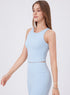 Side view of woman in light blue sleeveless workout set with fitted tank top and leggings.