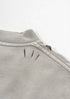 Stitch accents near the collar on back of light grey t-shirt.