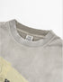 Close-up of distressed neckline on light grey graphic t-shirt.