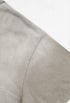 Light grey t-shirt shoulder seam and sleeve construction close-up.