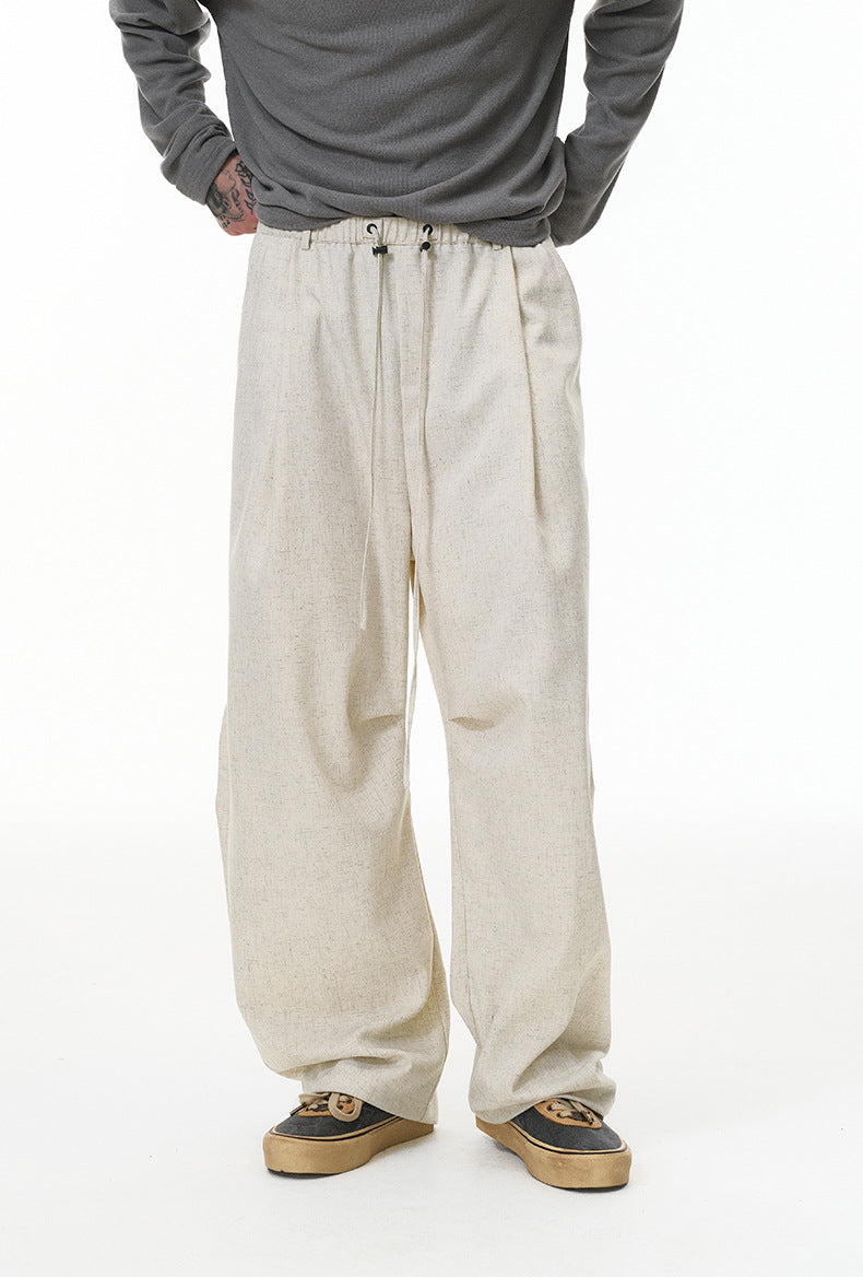 Linen wide-leg trousers in light beige with drawstring waist, relaxed streetwear fit
