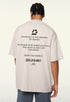 Model wearing apricot t-shirt with “LOADING...” print and motivational text on back.