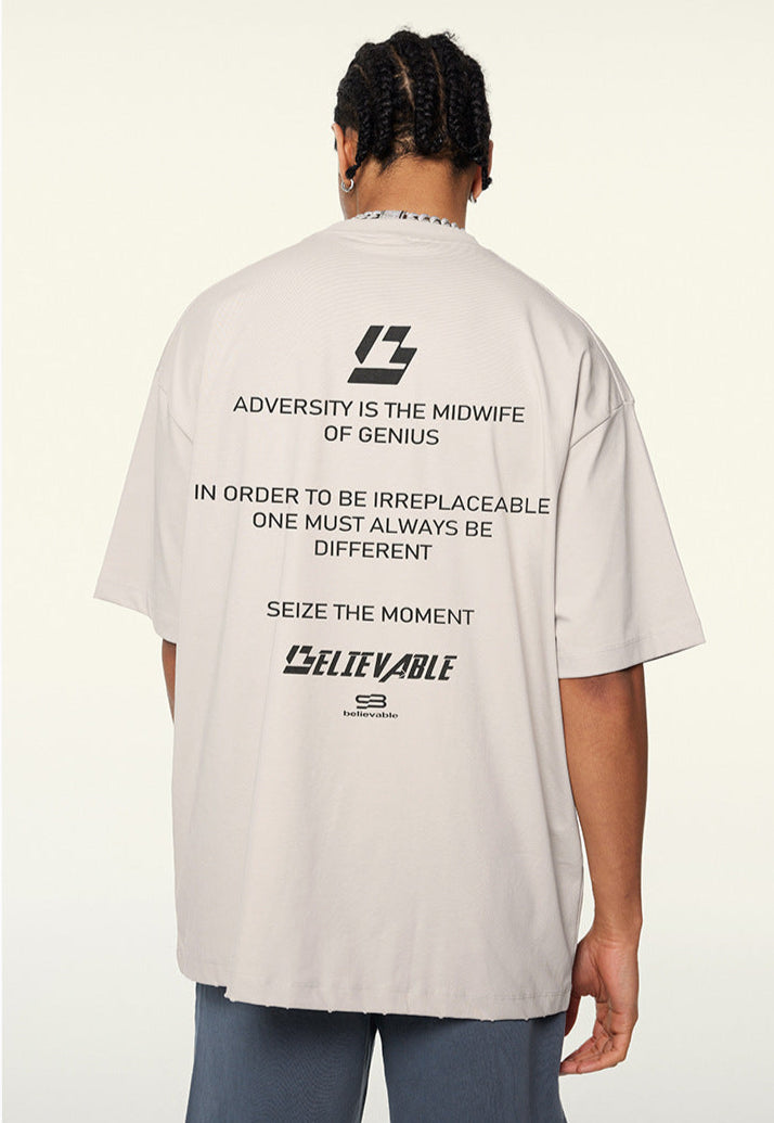 Model wearing apricot t-shirt with “LOADING...” print and motivational text on back.