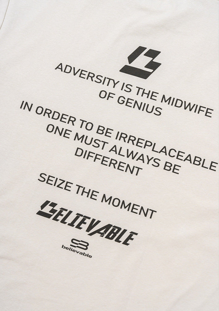 Close-up of back text print on cream tee.