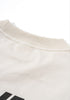 Collar and back neck stitching detail of cream tee,