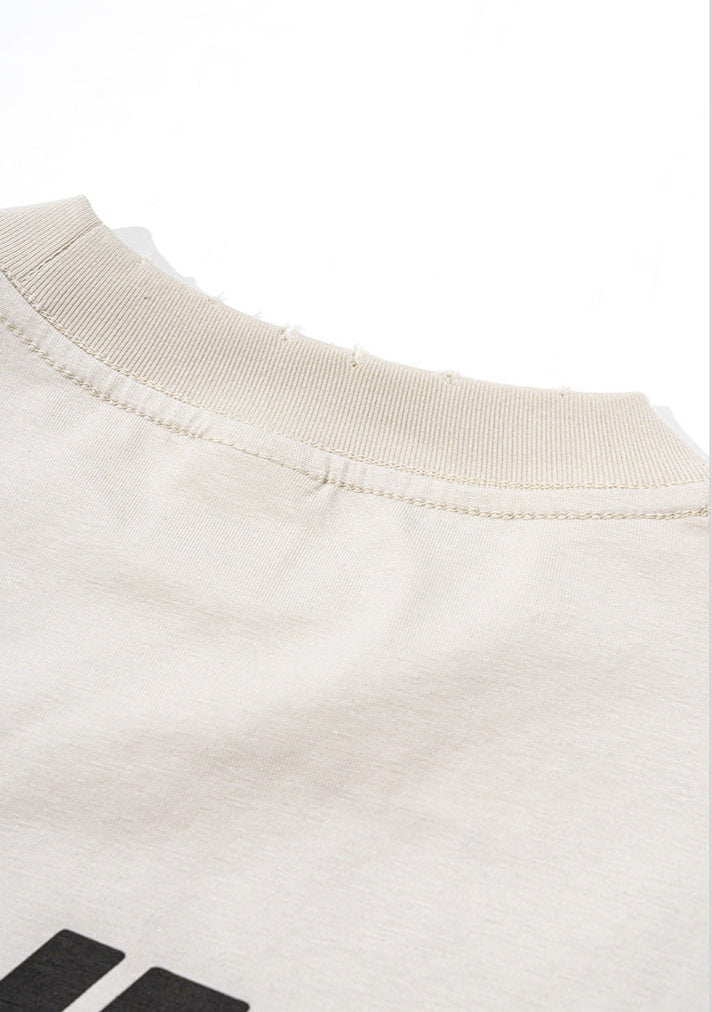 Collar and back neck stitching detail of cream tee,