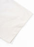Hem detail on short sleeve of apricot t-shirt.