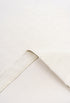 Inside-out stitching and fabric texture of cream t-shirt.
