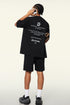 Back view of black tee showing motivational text and branding.