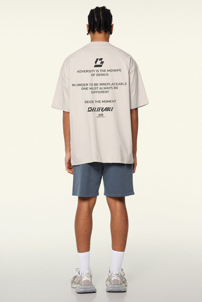 Back of cream loading tee featuring motivational quotes in black text.