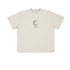 Flat-lay of cream T-shirt with black loading icon and text.