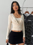 full-length front, long sleeve crop top in light almond, draped cowl, square neck, mini skirt styling