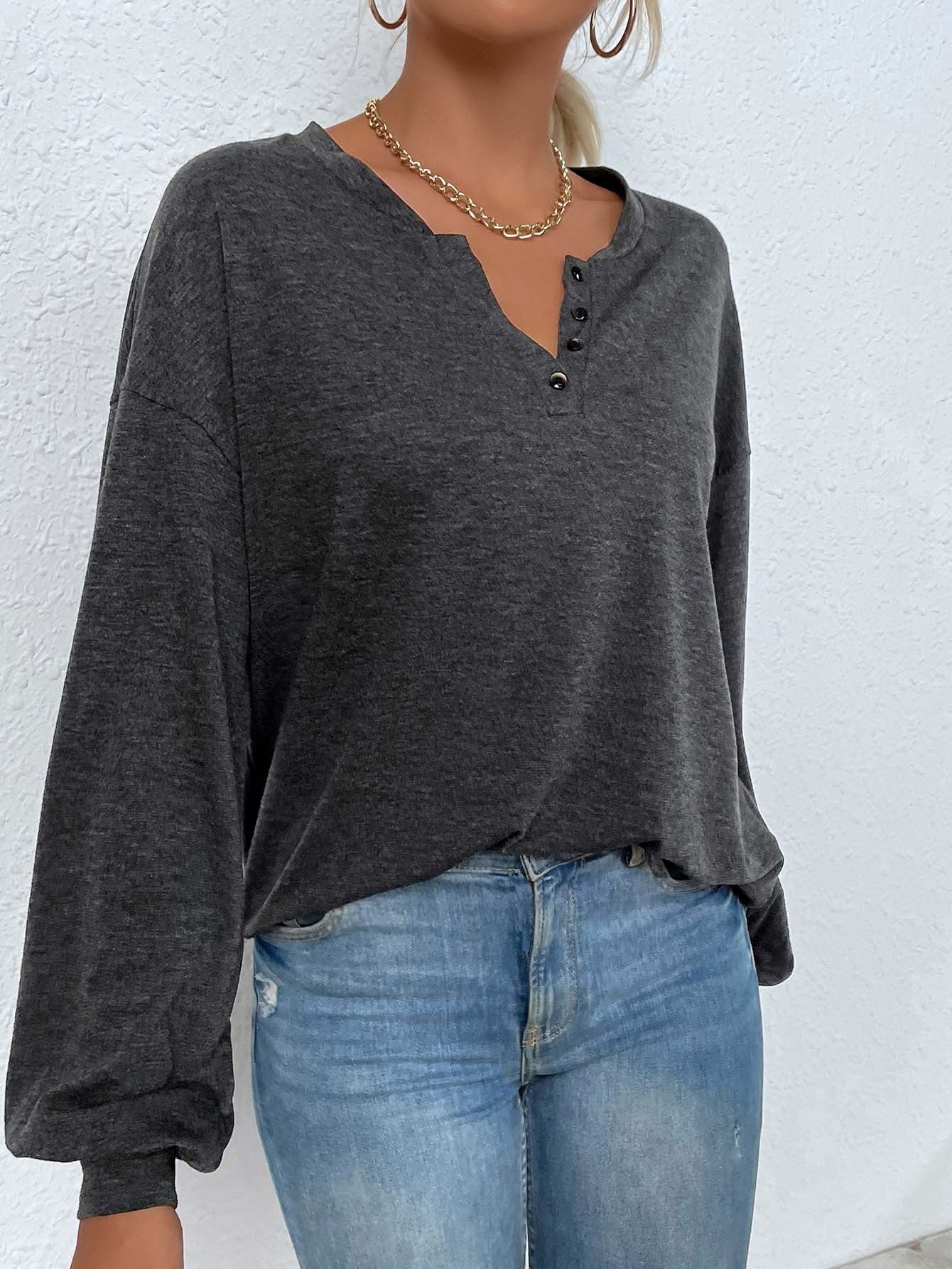 side angle, relaxed fit mélange henley with blouson sleeves and curved hem