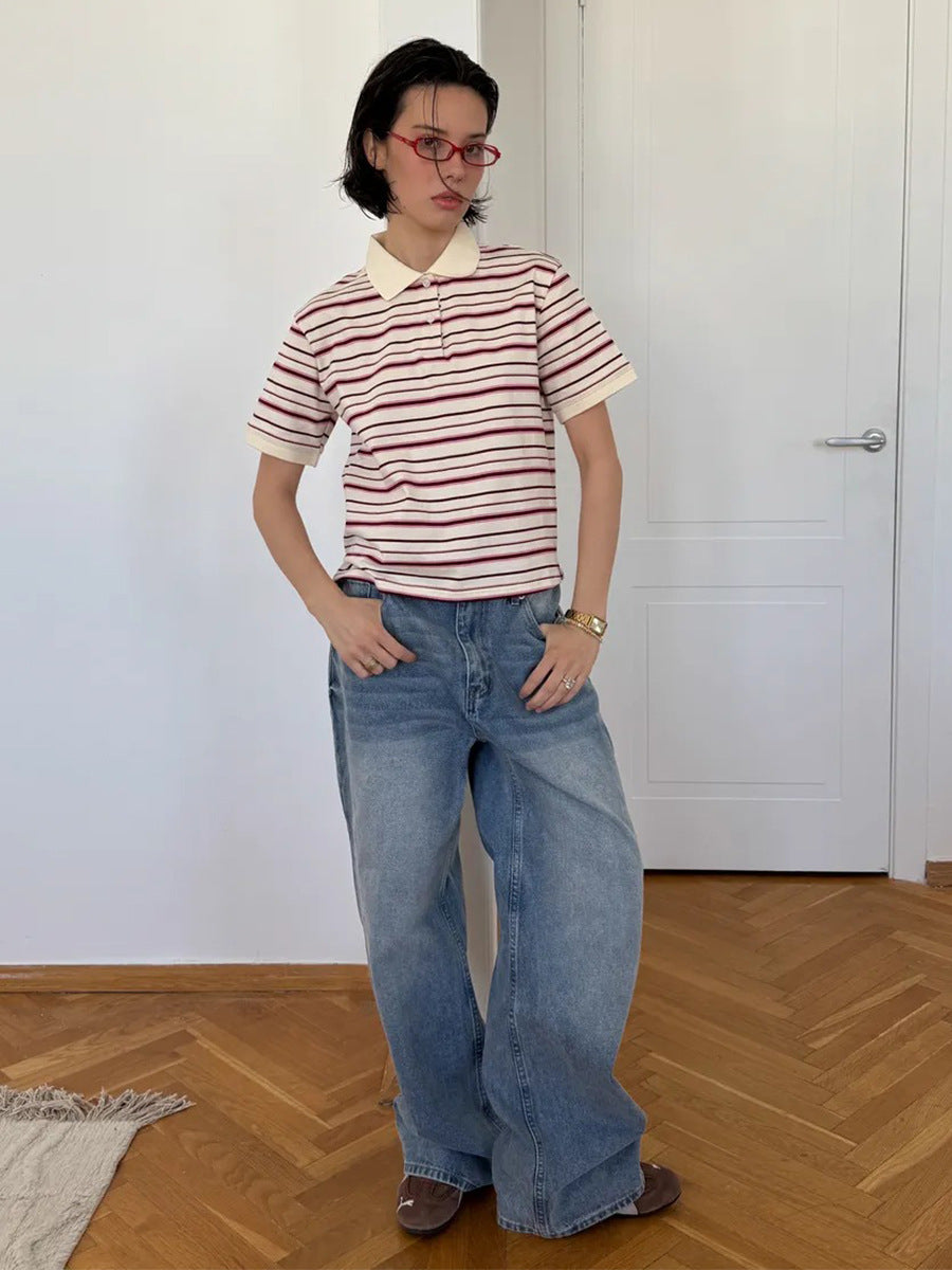 Full-body view of model in retro striped polo shirt and oversized wide-leg jeans.