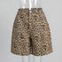 Beige leopard print cotton shorts with front pockets and button closure in mannequin