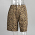 Khaki Yellow leopard print cotton shorts with front pockets and button closure in mannequin