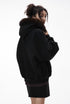 Back view of black fur-hood zip jacket on female model.