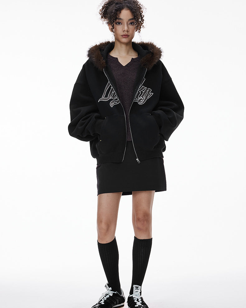 Female model in black fur-hood zip jacket, full body front.