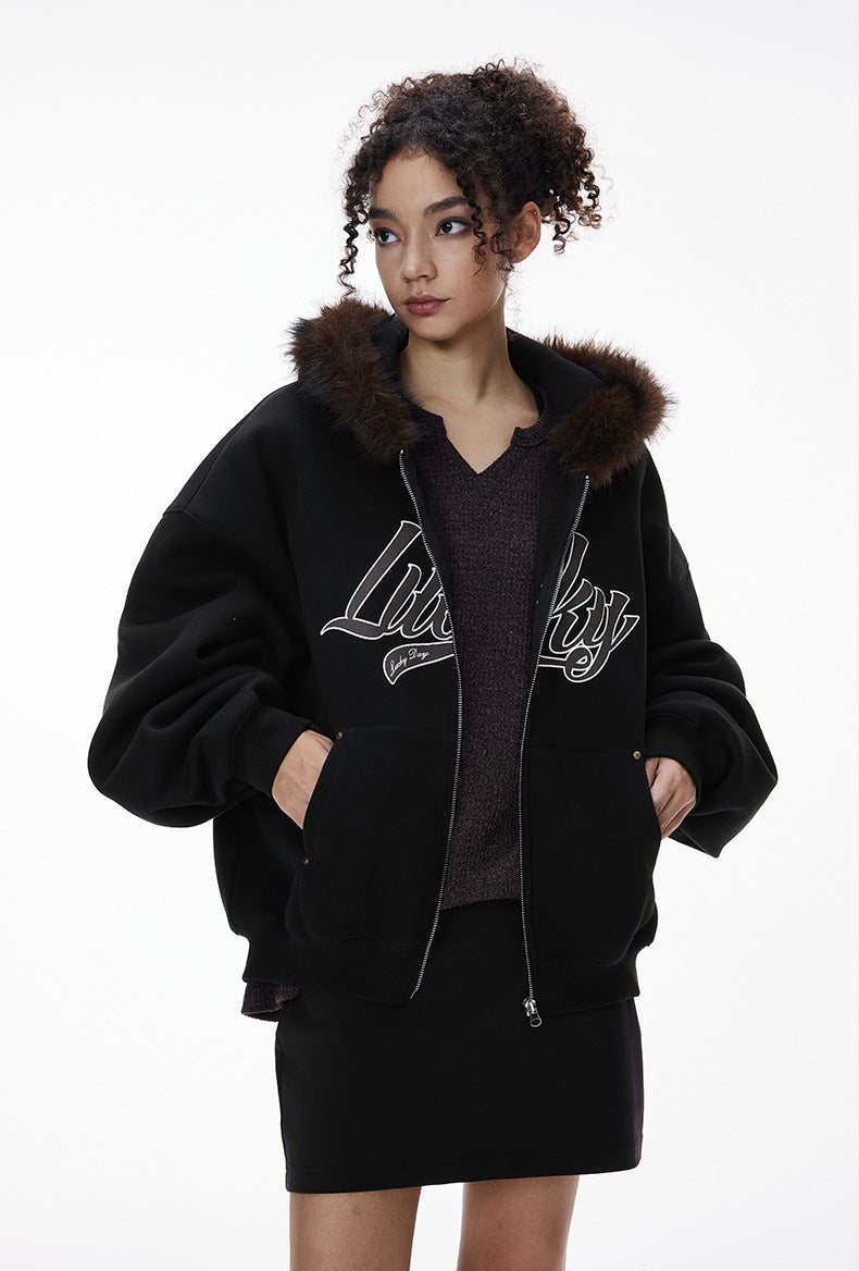 Female model in black jacket, hands in pockets, front view.