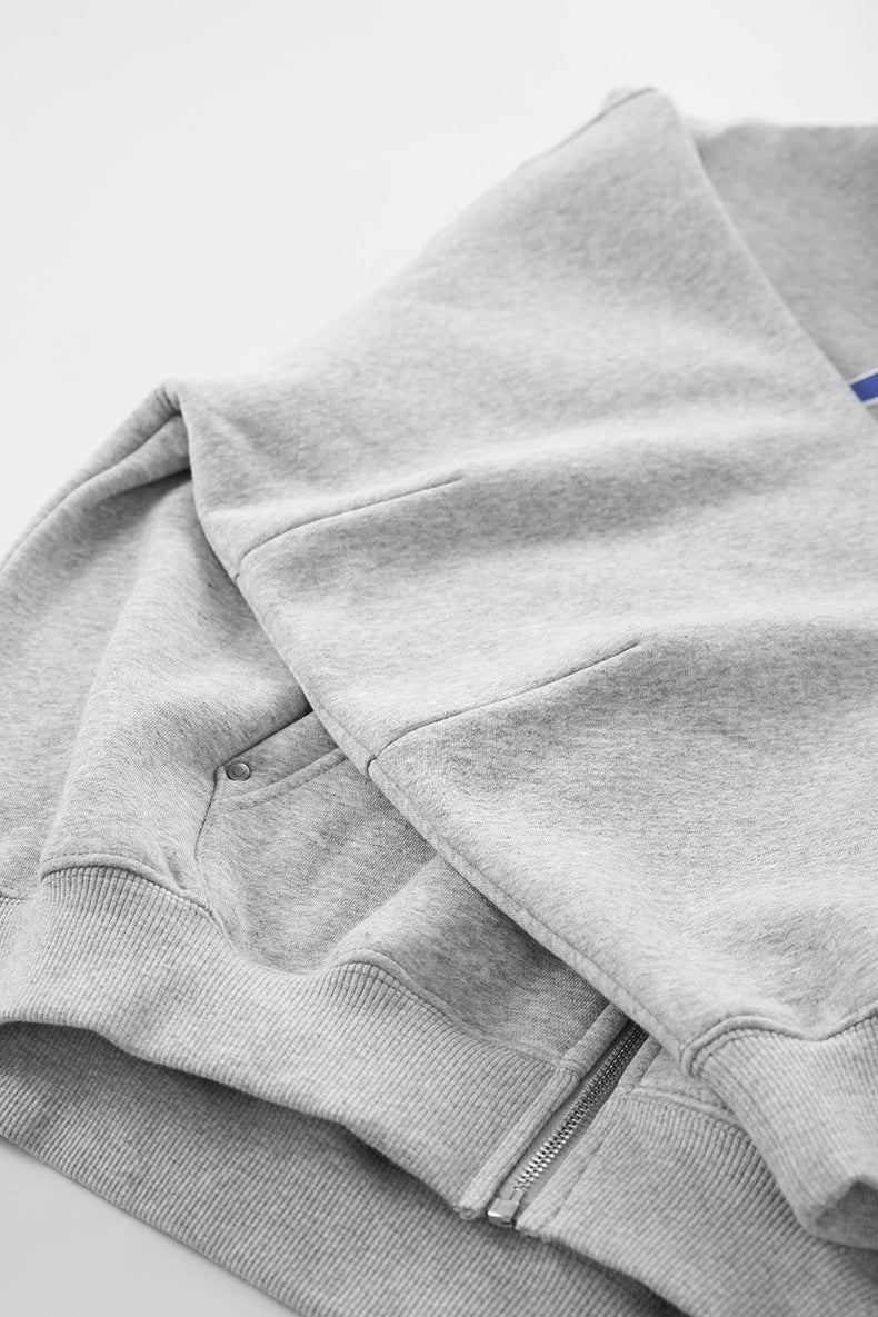 Soft brushed fleece fabric of gray jacket, stacked folds.