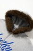 Plush fur hood trim on gray jacket, macro detail.