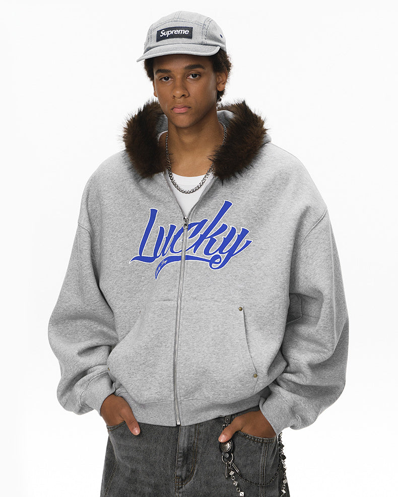 Male model in gray “Lucky” fur-hood jacket, hands in pockets.
