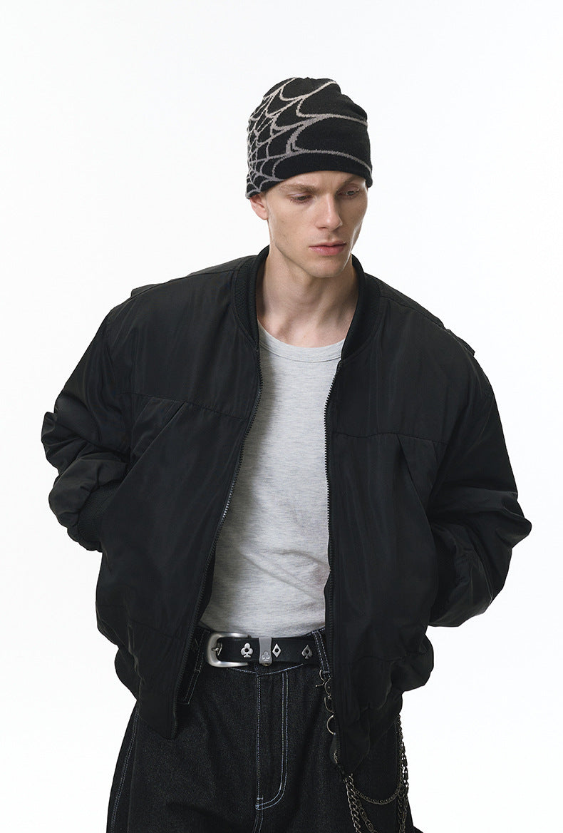 Black bomber with cap, hands in pockets, minimalist front look