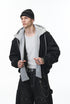Black bomber layered over gray hoodie, zip open, street style