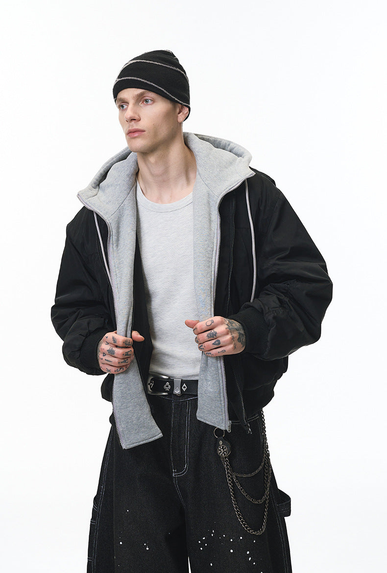 Black bomber layered over gray hoodie, zip open, street style