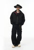 Model in black bomber jacket, zipped hoodie, standing straight