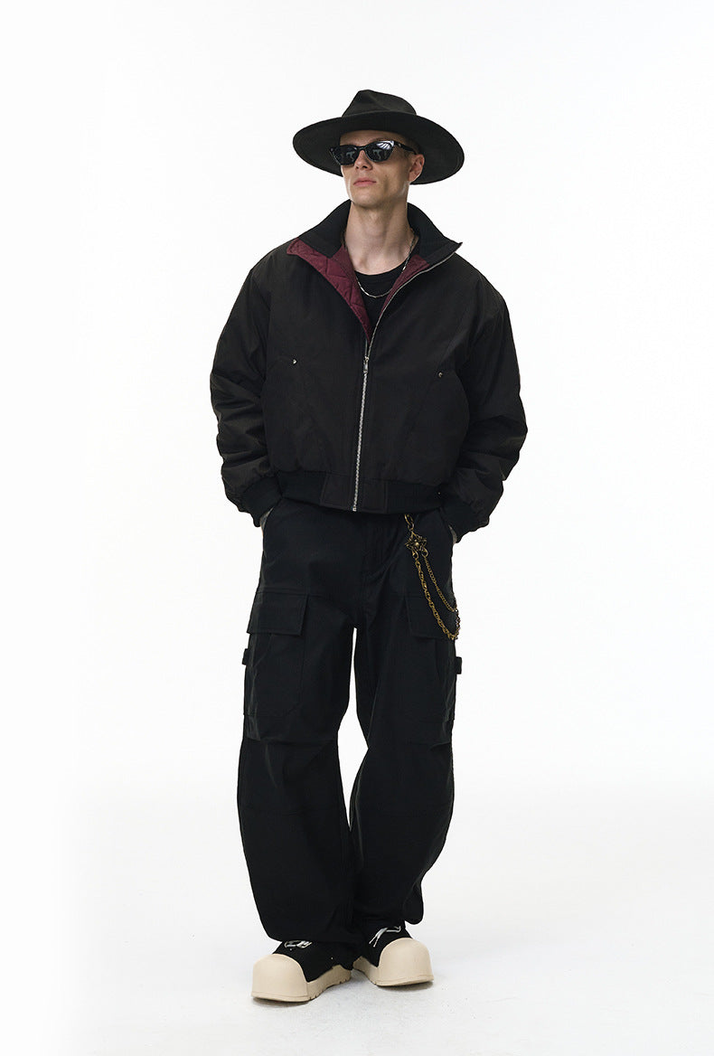 Model in black bomber jacket, zipped hoodie, standing straight