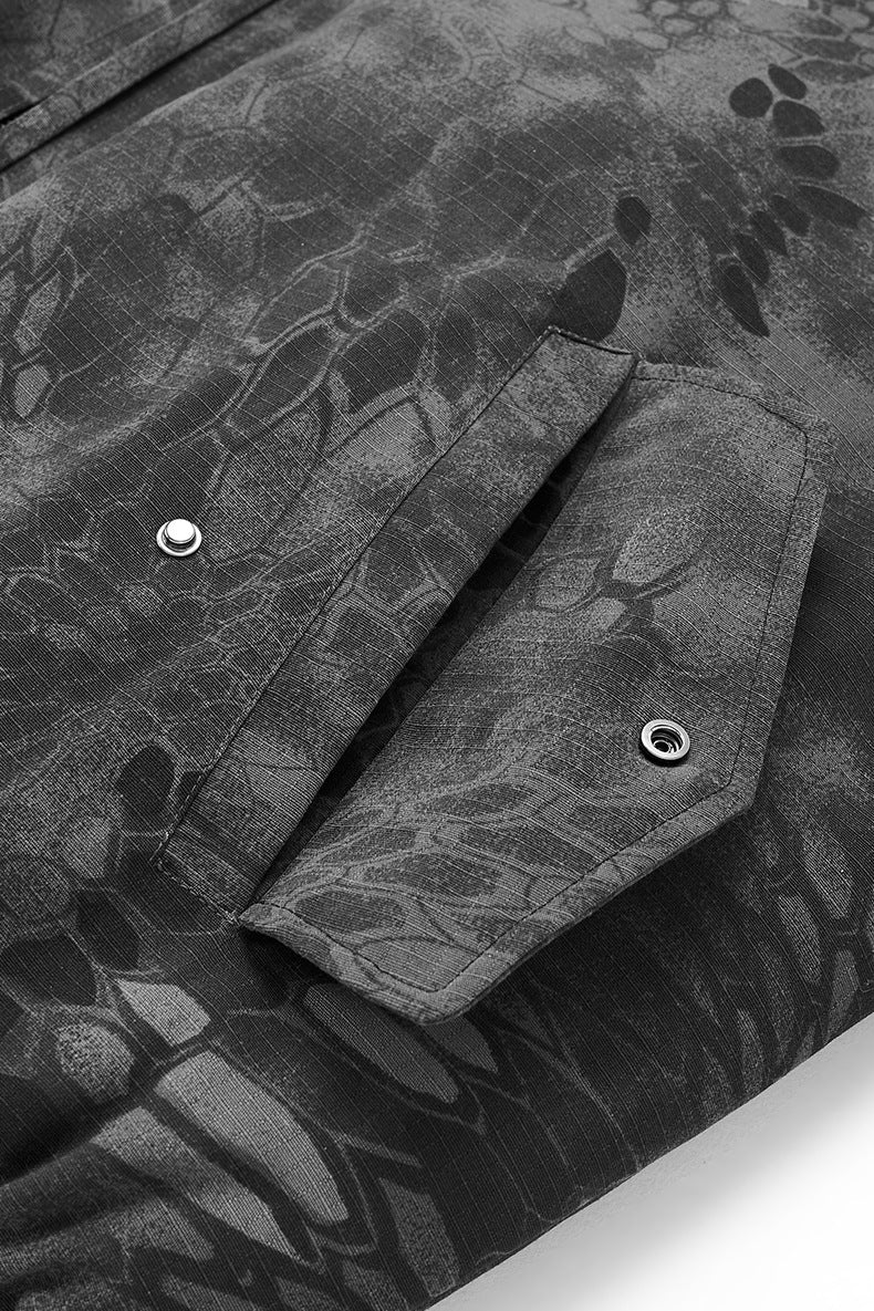 Pocket flap with snap close-up on dark gray bomber jacket
