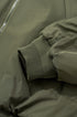 Ribbed cuff and sleeve detail on olive bomber jacket