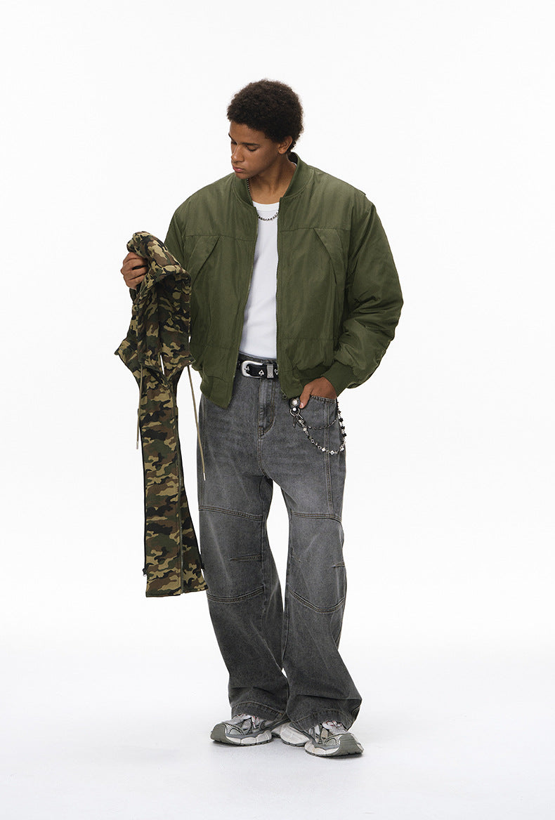 Olive bomber with detachable camo insert held in hand, zip front