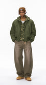 Full-length olive bomber jacket, hands in pockets, hood down