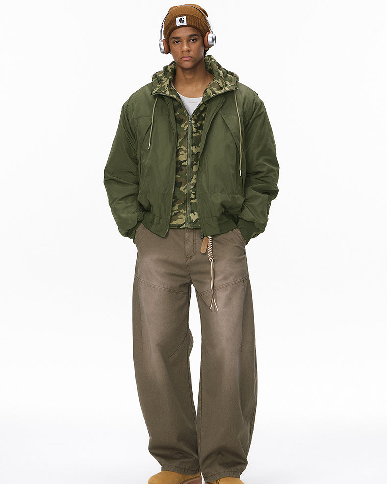 Full-length olive bomber jacket, hands in pockets, hood down