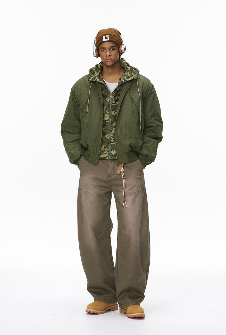 Full-length olive bomber jacket, hands in pockets, hood down