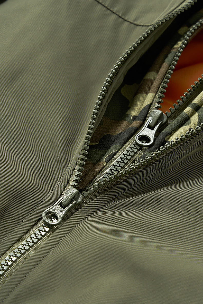Zipper close-up on olive bomber jacket with orange lining peek