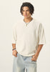Medium front view of model wearing an off white 100% cotton french terry raw hem short sleeve tee.