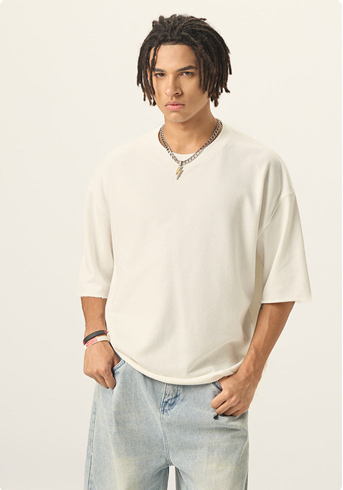 Medium front view of model wearing an off white 100% cotton french terry raw hem short sleeve tee.