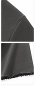 Close up view showing shoulder seam stitching and raw edge distressed sleeve hem on heavy cotton t shirt.