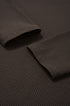 Close-up of brown long sleeve tshirt fabric with rolled-up sleeve