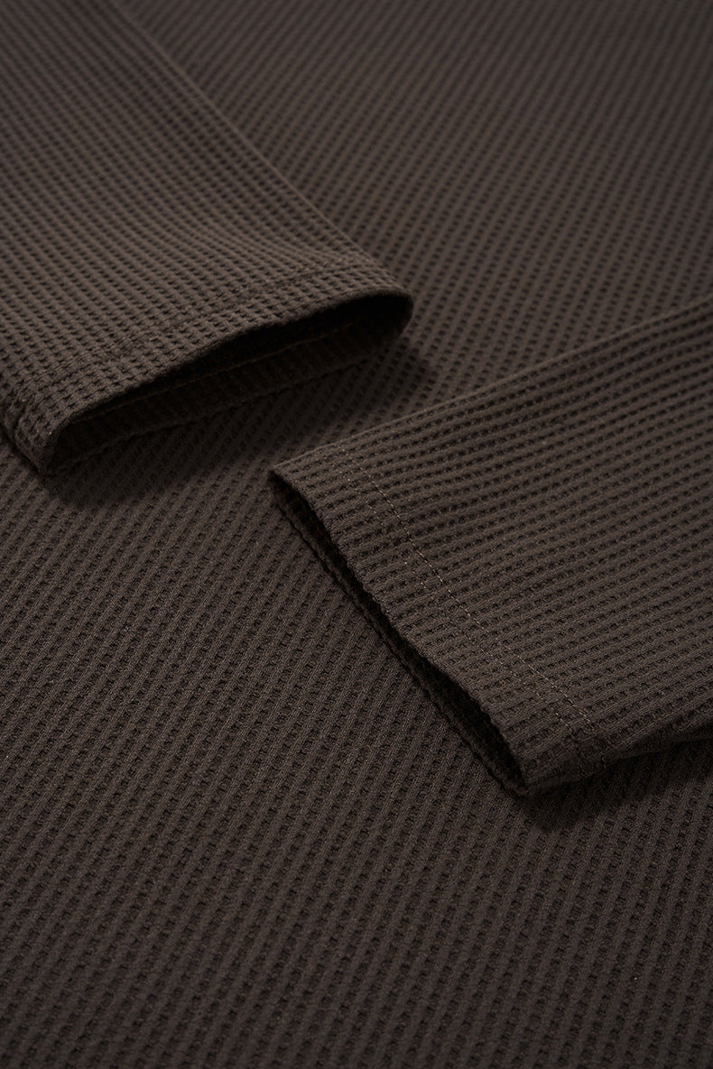 Close-up of brown long sleeve tshirt fabric with rolled-up sleeve