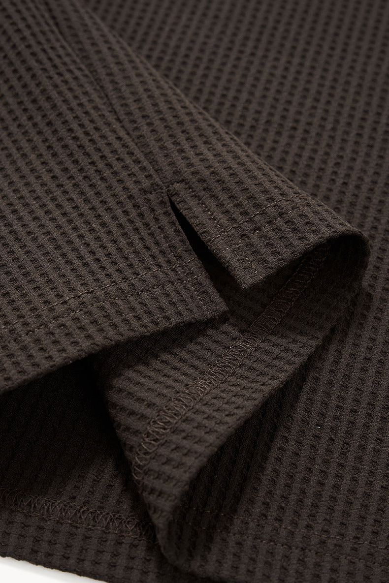 Close-up of brown long sleeve t shirt waffle knit seagull collar fabric with a waffle pattern.