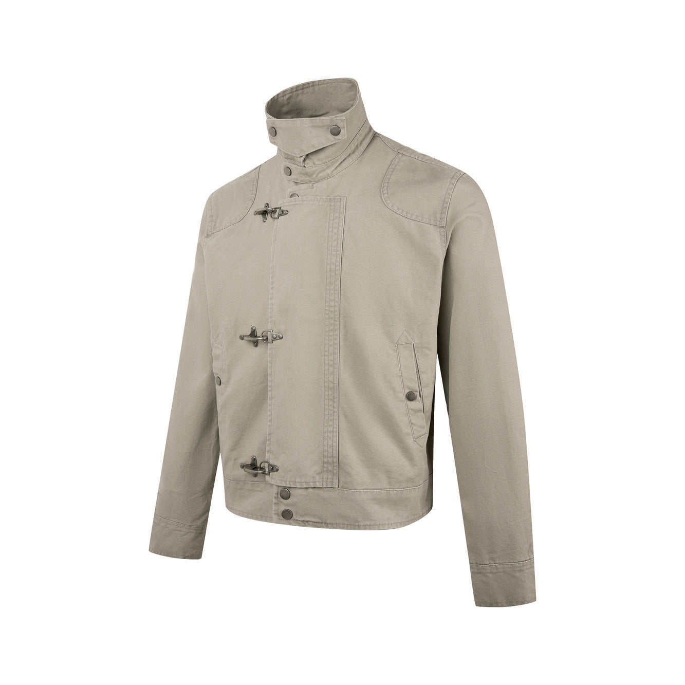 Product shot of a mens khaki beige cotton canvas jacket with metal buckle clasps and high collar on white background.