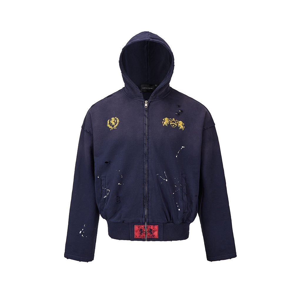 Front product view of a mens navy blue distressed zip up hoodie with paint splatters and gold chest embroidery.
