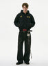 Full length view of model styling a washed black distressed zip up hoodie with wide leg printed jeans and boots.