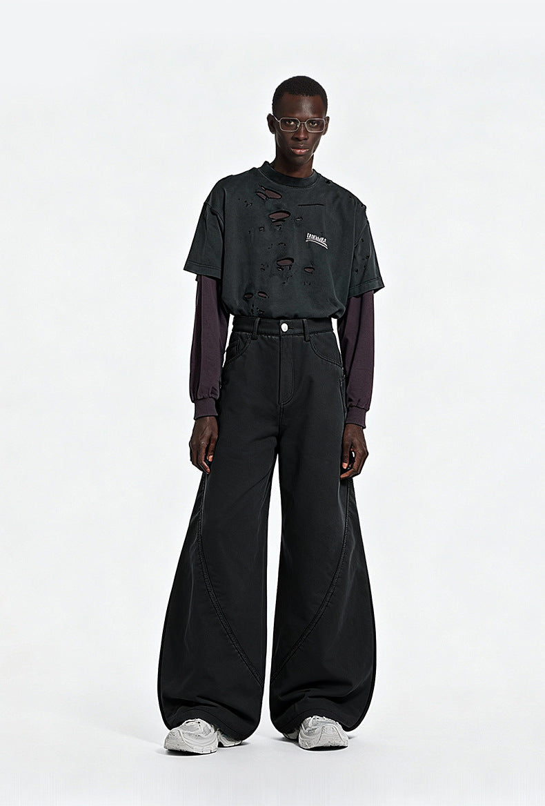 Full length shot of model styling washed black fleece lined wide leg curved seam cargo pants with a long sleeve tee.