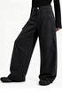 Side view of model wearing washed black fleece lined cargo pants featuring a wide-leg curved silhouette.