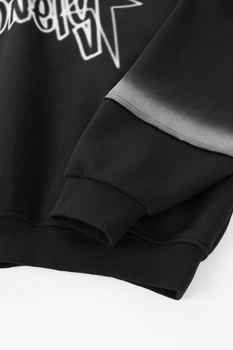 Cuff and sleeve graphic detail on black hoodie, rib knit hem.